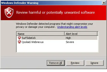Windows Defender 2006 warning window asking the user to review harmful or potentially unwanted software, with Remove All, Review and Ignore buttons